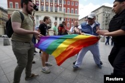 FILE PHOTO - LGBT activists are accosted by antigay protesters in central Moscow.