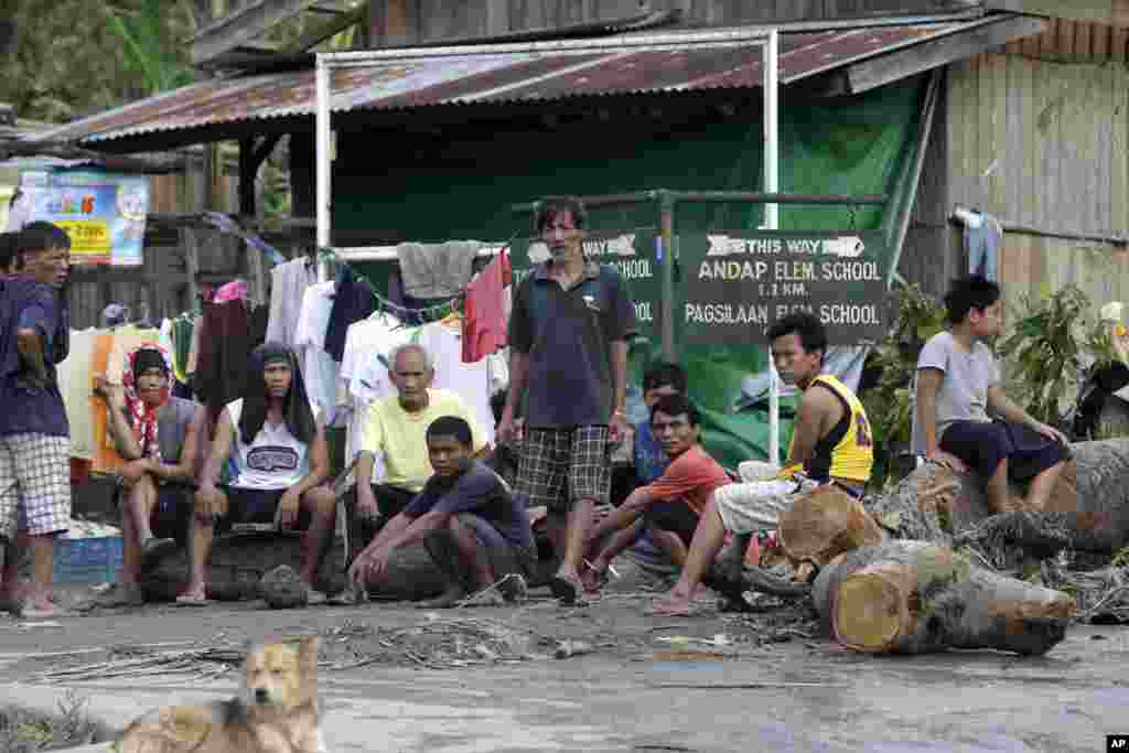 Residents wait for relief supplies at the flash flood-hit village of Andap, New Bataan township, Compostela Valley in southern Philippines, December 5, 2012, a day after the devastating Typhoon Bopha made landfall. 
