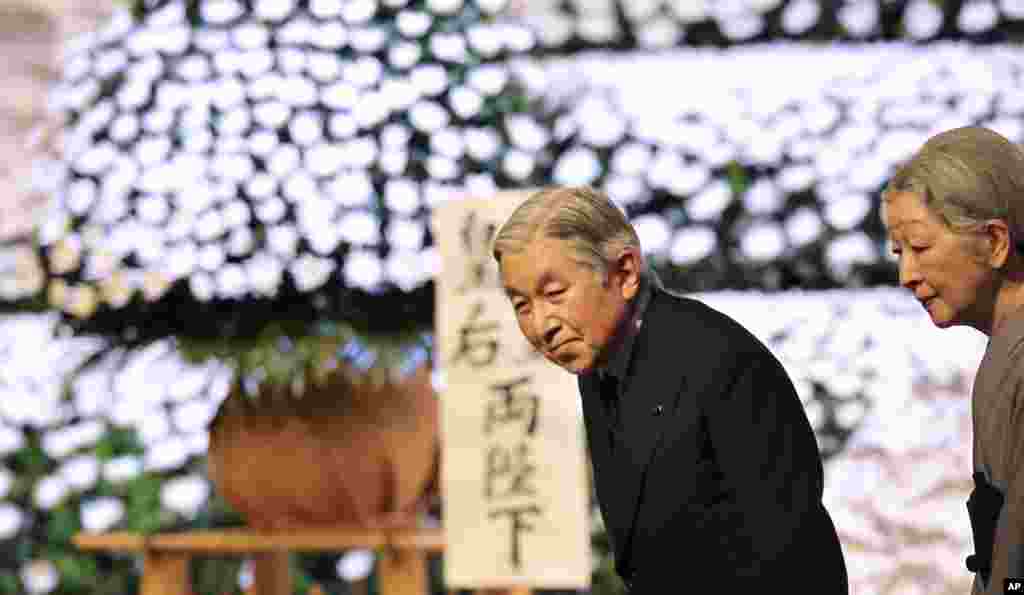 Kaisar Jepang Akihito dan permaisuri Michiko meninggalkan upacara penghormatan bagi para korban gempa bumi dan tsunami 11 Maret 2011 di Tokyo. (AP/Junji Kurokawa)