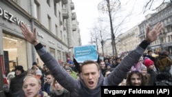 FILE - In this Sunday, Jan. 28, 2018 file photo, Russian opposition leader Alexei Navalny, center, attends a rally in Moscow, Russia. (AP Photo/Evgeny Feldman, File)