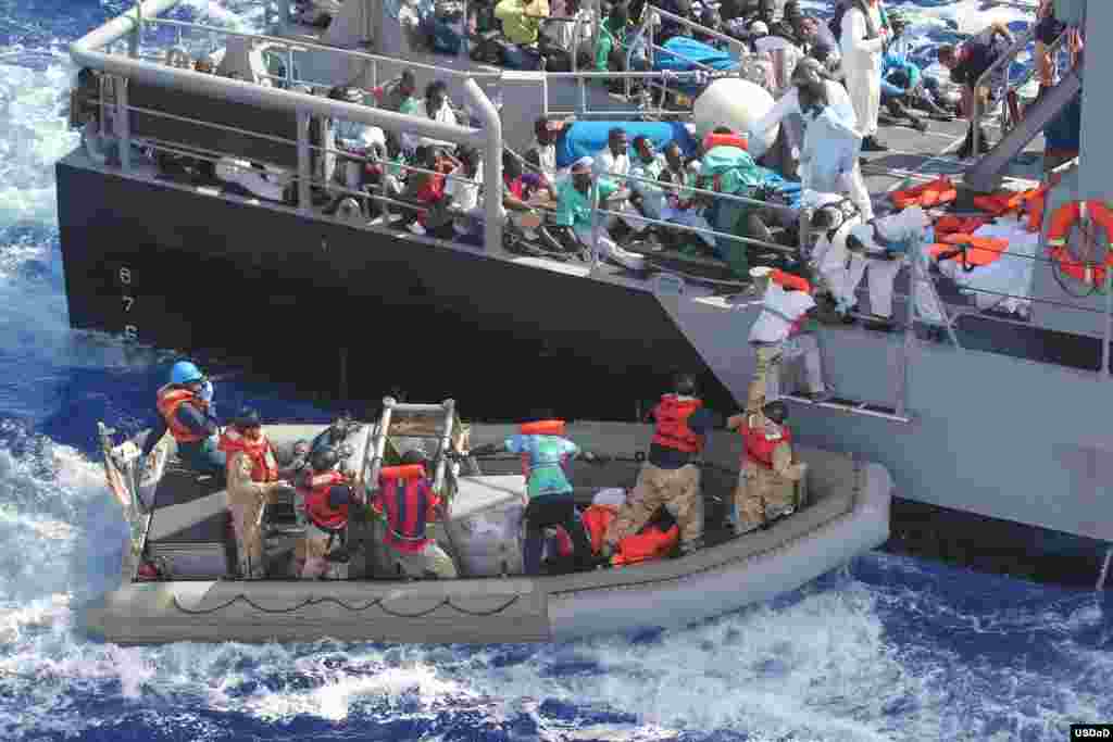 Distressed persons are transferred from the amphibious transport dock ship USS San Antonio (LPD 17) to Armed Forces of Malta offshore patrol vessel P52 in the Mediterranean Sea. San Antonio provided food, water, medical attention, and temporary shelter to the rescued.