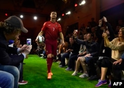 Portugal's football team forward Cristiano Ronaldo arrives to an interview during the presentation of new Nike football boots in Madrid, April 25, 2014.