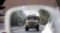 A patrolling U.S. armored vehicle is reflected in the mirror of a car in Kabul, Afghanistan, Aug. 23, 2017. 