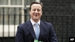 British Prime Minister David Cameron leaves 10 Downing Street to attend Prime Minister's Questions at the House of Commons in London, February 02, 2011