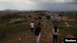 FILE - Venezuelan military deserters of the National Guard, who don't want to be identified, stand at the border point with Venezuela, in Pacaraima, Brazil, April 11, 2019. 