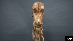 FILE - This photograph taken on March 24, 2022 shows a "Ngil" mask of the Fang people of Gabon which is estimated at 300,000/400,000 euros and which will be auctioned on March 26, 2022 at the Montpellier auction house.