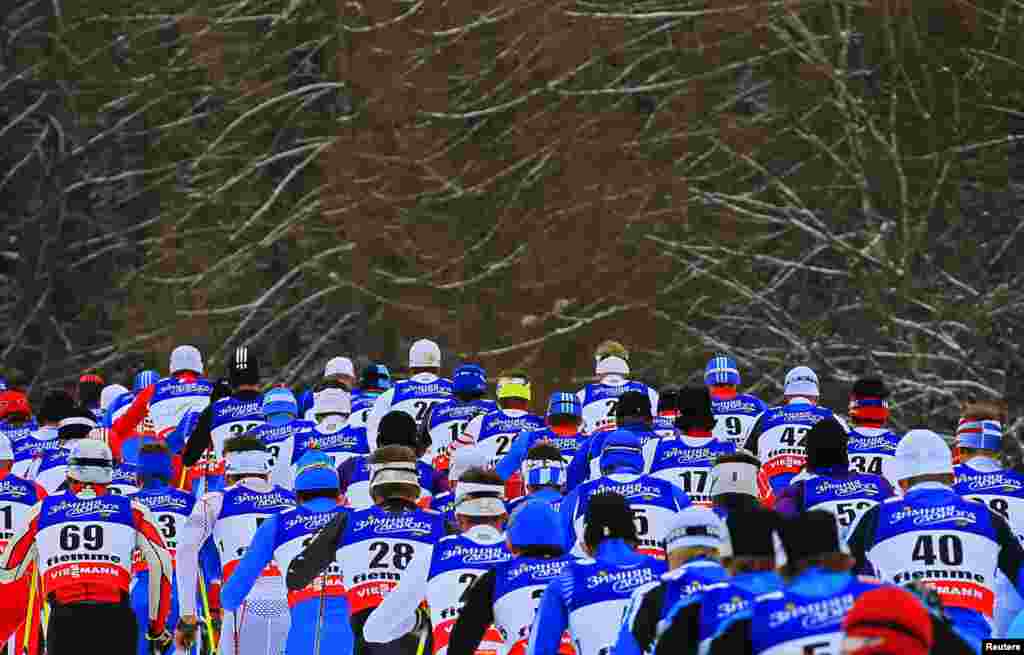 Competitors ski in the men's skiathlon competition at the Nordic World Ski Championships in the northern mountain resort of Tesero in Val di Fiemme, Italy.
