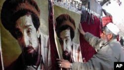 An Afghan man sells carpets with the picture of assassinated Northern Alliance leader Ahmad Shah Massoud on them in a Kabul market on January 24, 2002. (file photo)