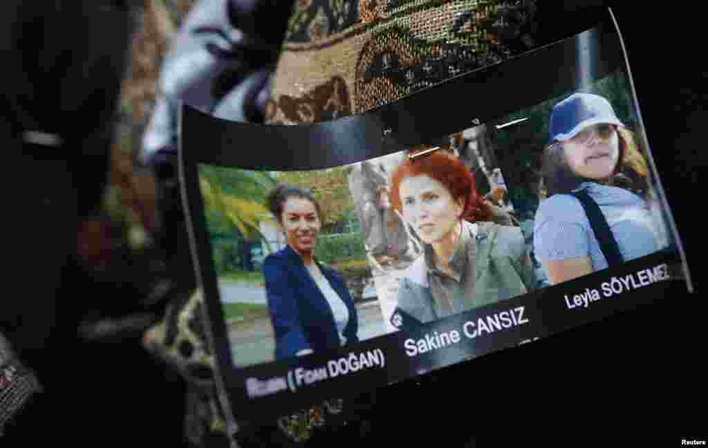 Portraits of presumed victims are seen pinned on a member of the Kurdish community's coat as they gather next to the entrance of the Information Centre of Kurdistan in Paris, France, January 10, 2013.