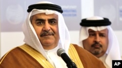 FILE - Bahraini Foreign Minister Sheik Khalid bin Ahmed Al Khalifa, left, listens to journalists while standing with Finance Minister Sheik Ahmed bin Mohammed Al Khalifa during a conference.