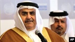 FILE - Bahraini Foreign Minister Sheik Khalid bin Ahmed Al Khalifa, left, listens to journalists while standing with Finance Minister Sheik Ahmed bin Mohammed Al Khalifa during a conference.