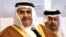 FILE - Bahraini Foreign Minister Sheik Khalid bin Ahmed Al Khalifa, left, listens to journalists while standing with Finance Minister Sheik Ahmed bin Mohammed Al Khalifa during a conference.