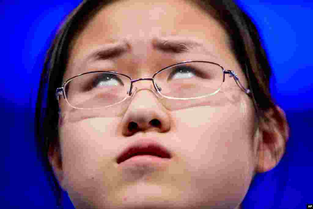 Sophia Han, 14, of Tianjin, China, thinks how to spell her word &quot;vermicide&quot; during the 2015 Scripps National Spelling Bee in Oxon Hill, Maryland, USA.