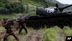 North Korean soldiers from the historic 105 tank unit fire during a military exercise at an undisclosed location in North Korea, on July 27, 2012, marking the 59th anniversary of the armistice that ended the 1950-53 Korean War.