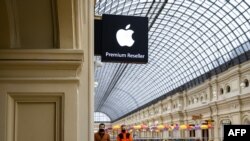 People pass by an Apple store at the State Department Store, GUM, in central Moscow on April 27, 2021.
