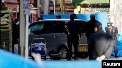 Policemen stand next to a car which plowed into pedestrians on New Year's day in Tokyo, Japan, Jan. 1, 2019.