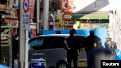 Policemen stand next to a car which plowed into pedestrians on New Year's day in Tokyo, Japan, Jan. 1, 2019.