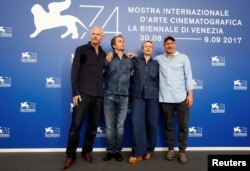 FILE - Director Martin McDonagh, actors Sam Rockwell, Frances McDormand and Woody Harrelson pose during a photocall for the movie "Three Billboards Outside Ebbing, Missouri" at the 74th Venice Film Festival in Venice, Italy, Sept. 4, 2017.