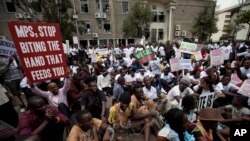 Kenyan demonstrators, some chained to each other, gather near the gate of parliament in Nairobi, Kenya, May 14, 2013.