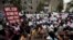 Kenyan demonstrators, some chained to each other, gather near the gate of parliament in Nairobi, Kenya, May 14, 2013.