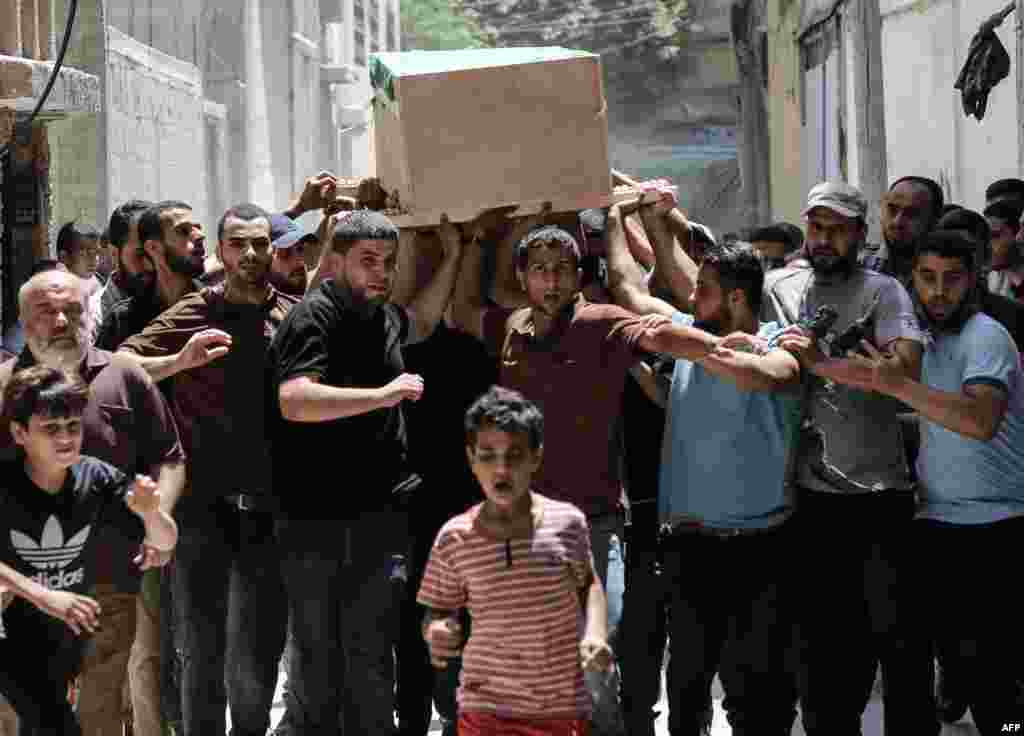 Palestinian mourners carry the body of Obada Farwana, during his funeral in Gaza City.