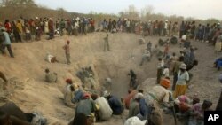 FILE - Gangs of illegal miners dig for diamonds in Marange, eastern Zimbabwe, Nov. 1, 2006. 