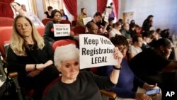 FILE - Suzanne Lanier, front left, opposes a bill pushed by the Tennessee secretary of state that would impose new restrictions on groups that hold voter registration drives in Nashville, Tenn., April 15, 2019. 