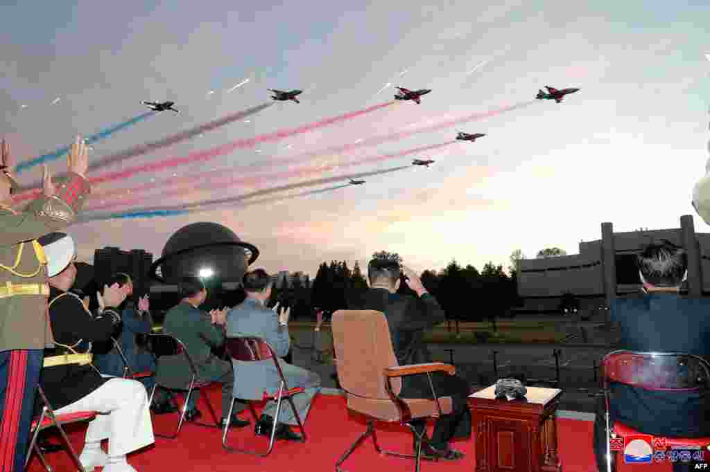 North Korean leader Kim Jong Un, 2nd right, watches a demonstration flight during the opening ceremony of the defense development exhibition &quot;Self-Defence-2021&quot; in Pyongyang, in this picture taken October 11, 2021, and released from North Korea&#39;s official Korean Central News Agency on October 12.