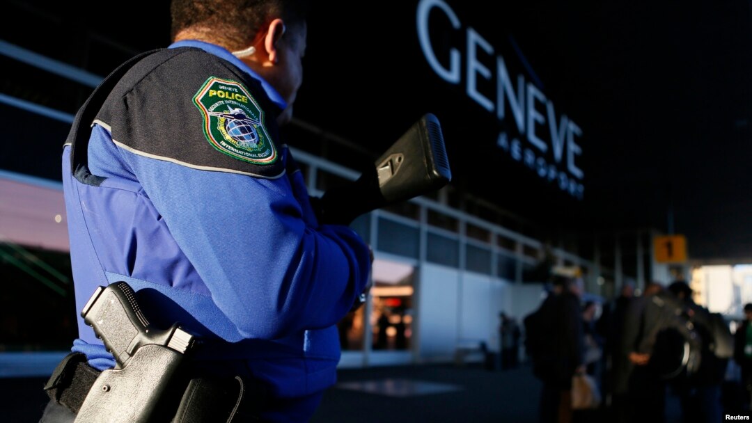 FILE - A County of Geneva police officer stands guard outside Cointrin airport in Geneva, Switzerland, Dec. 10, 2015. 