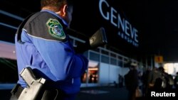 FILE - A County of Geneva police officer stands guard outside Cointrin airport in Geneva, Switzerland, Dec. 10, 2015. 