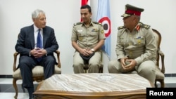 U.S. Defense Secretary Chuck Hagel, left, speaks with Egyptian Army Chief of Staff Major General Sedki Sobhi upon his arrival in Cairo, April 24, 2013.