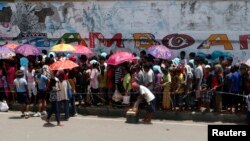 Evacuees queue for relief goods in a sports stadium which has been turned into an evacuation center Zamboanga, Sept. 20, 2013.