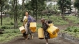 Residents carry jerrycans on their way to collect water from a water point installed by Doctors Without Borders (MSF) in Mugunga, Goma, Democratic Republic of Congo, Feb. 11, 2025. 