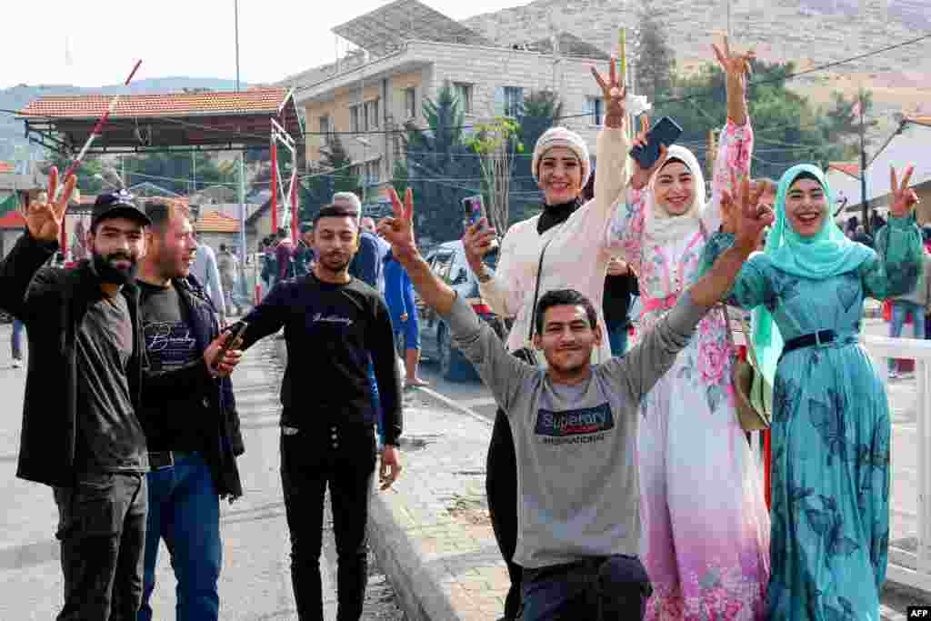 Syrians celebrate as they return to Damascus via Lebanon's Masnaa border crossing east of Beirut on Dec. 8, 2024, following the fall of the Syrian capital to anti-government fighters.