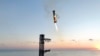 This image provided by SpaceX shows SpaceX's mega rocket booster returning to the launch pad to be captured during a test flight, Oct. 13, 2024, in Boca Chica, Texas. (SpaceX via AP)