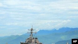 The guided-missile destroyer USS John S. McCainapproaches Da Nang, Vietnam for a scheduled five-day engagement commemorating the 15th anniversary of the normalization of relations between Vietnam and the United States