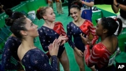 U.S. gymnasts, from left, Aly Raisman, Gabby Douglas, Madison Kocian, Lauren Hernandez and Simone Biles wait for the score during the artistic gymnastics women's qualification at the 2016 Summer Olympics in Rio de Janeiro, Brazil, Aug. 7, 2016. 