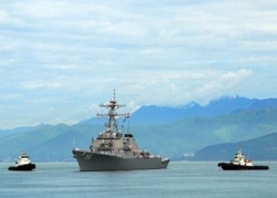 FILE - The guided-missile destroyer USS John S. McCain approaches Da Nang, Vietnam, May 7, 2019.