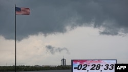 Ominous weather is seen above launch pad 39A at Cape Canaveral as the countdown clock continues on launch day at the Kennedy Space Center in Florida on May 27, 2020. - SpaceX's historic first crewed launch was set to proceed as scheduled Wednesday, NASA 