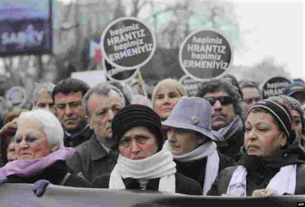 Tens of thousands of protesters, including his wife Rakel Dink, front center, march to mark the fifth anniversary of Turkish-Armenian journalist Hrant Dink's murder in Istanbul, Turkey, Thursday, Jan. 19, 2012 as outrage continues to grow over a trial tha