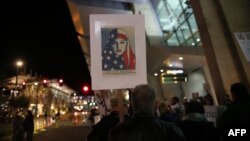 FILE - Protesters chant during a rally against the travel ban at San Diego International Airport, March 6, 2017.