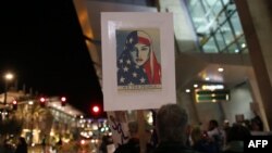 FILE - Protesters chant during a rally against the travel ban at San Diego International Airport in San Diego, March 6, 2017.
