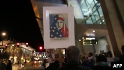 FILE - Protesters chant during a rally against the travel ban at San Diego International Airport on March 6, 2017, in San Diego.