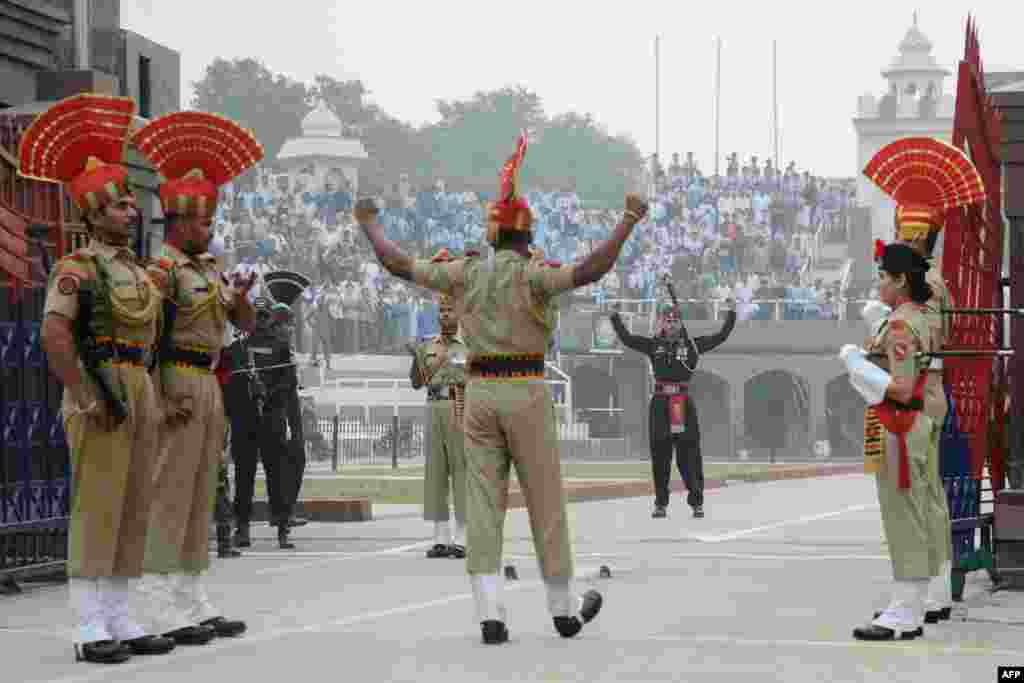 Indian Border Security Force personnel (brown) and Pakistani rangers (black) taking part in the daily beating of the retreat ceremony at the India-Pakistan Wagah Border, some 35km west of Amritsar, Oct, 30, 2017.