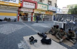 Iraqi security forces rest in Tahrir Square after the lifting of a curfew, following four days of nationwide anti-government protests that turned violent, in Baghdad, Oct. 5, 2019.