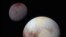 FILE - This composite of enhanced color images shows Pluto (lower right) and Charon (upper left), taken by NASA’s New Horizons spacecraft as it passed through the Pluto system on July 14, 2015.