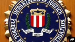FILE - The Federal Bureau of Investigation of the Department of Justice of the United States of America emblem at the U.S. embassy in Berlin, Aug. 10, 2007.