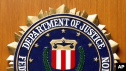 FILE - The Federal Bureau of Investigation of the Department of Justice of the United States of America emblem at the U.S. embassy in Berlin, Aug. 10, 2007.