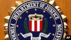 FILE - The Federal Bureau of Investigation of the Department of Justice of the United States of America emblem at the U.S. embassy in Berlin, Aug. 10, 2007.