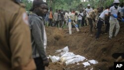 FILE - Red Cross volunteers bury the remains of civilians killed in the Democratic Republic of Congo North Kivu province village of Mukondi, March 9, 2023. At least 36 were killed when the Allied Democratic Forces, attacked the village and burned residents' huts.